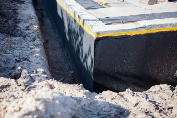Professional Waterproofing technician working in Lakeville, NY